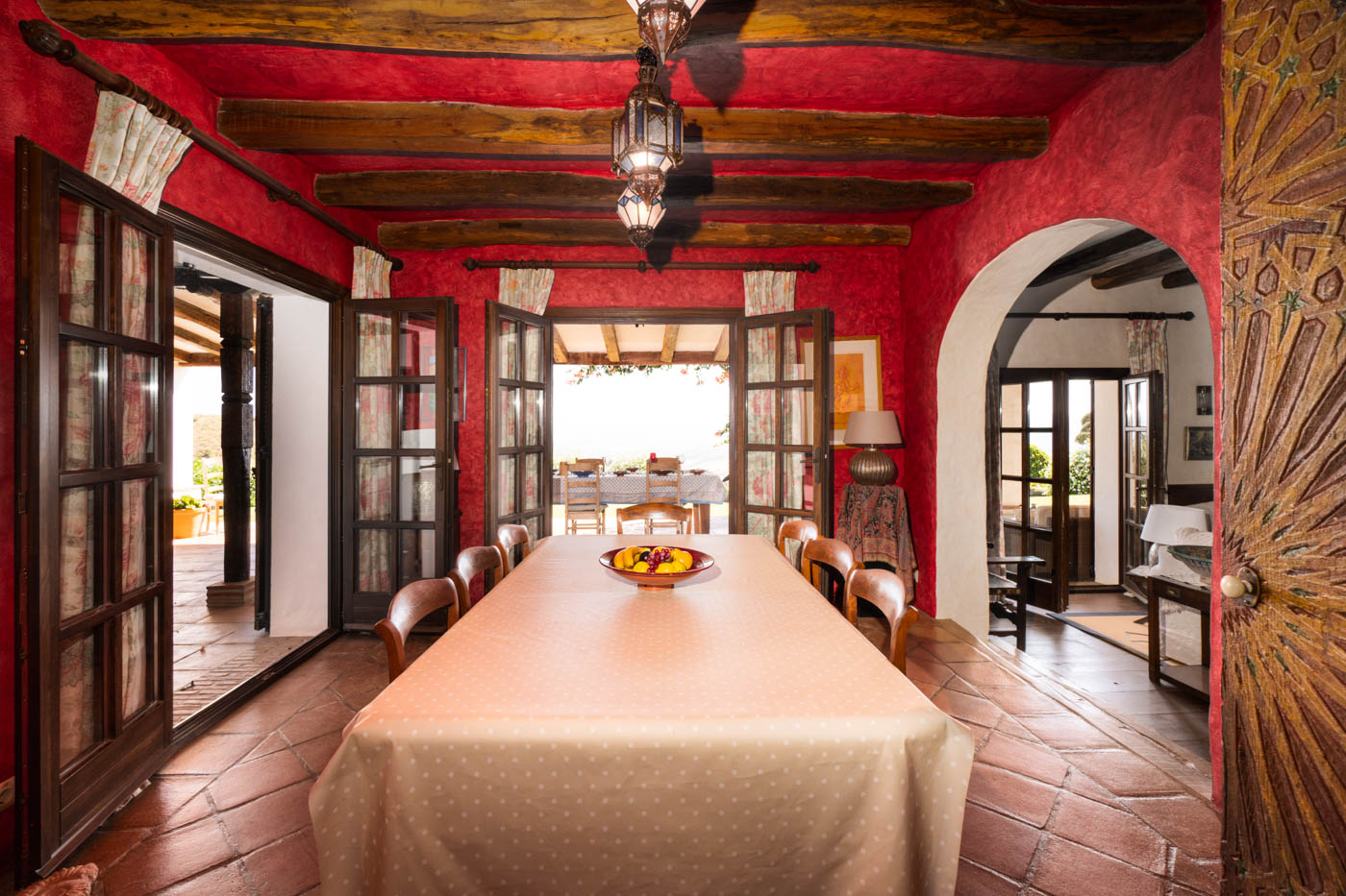 Dining room is next to kitchen with doors opening to terraces