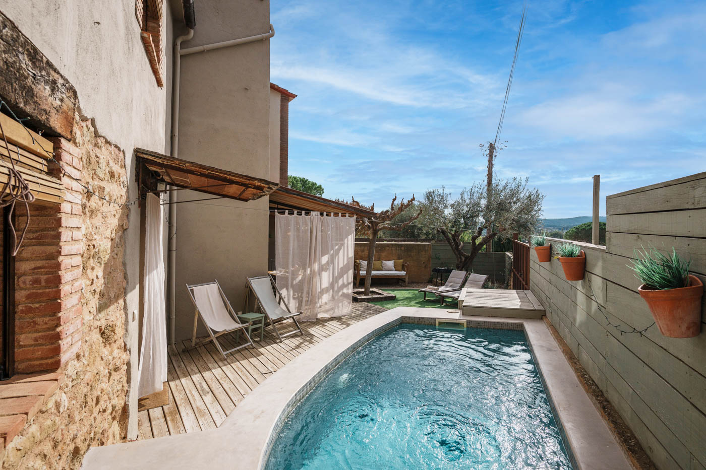 The pool occupies a private corner of the patio