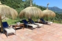 Relax under parasols by the pool