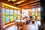Living area with large windows looking onto gardens