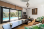 Living area overlooking swimming pool and mountains