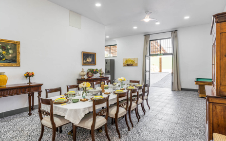 Open plan kitchen/dining with doors to barbecue area