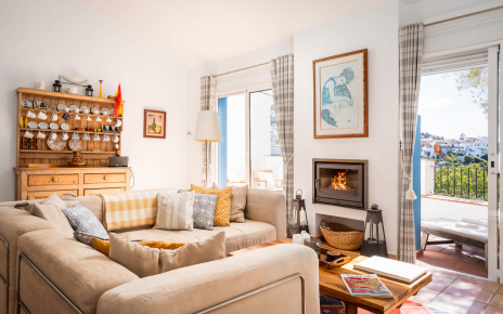 Living area with fireplace, terrace and views