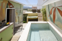 Outdoor area with plunge pool and awning 